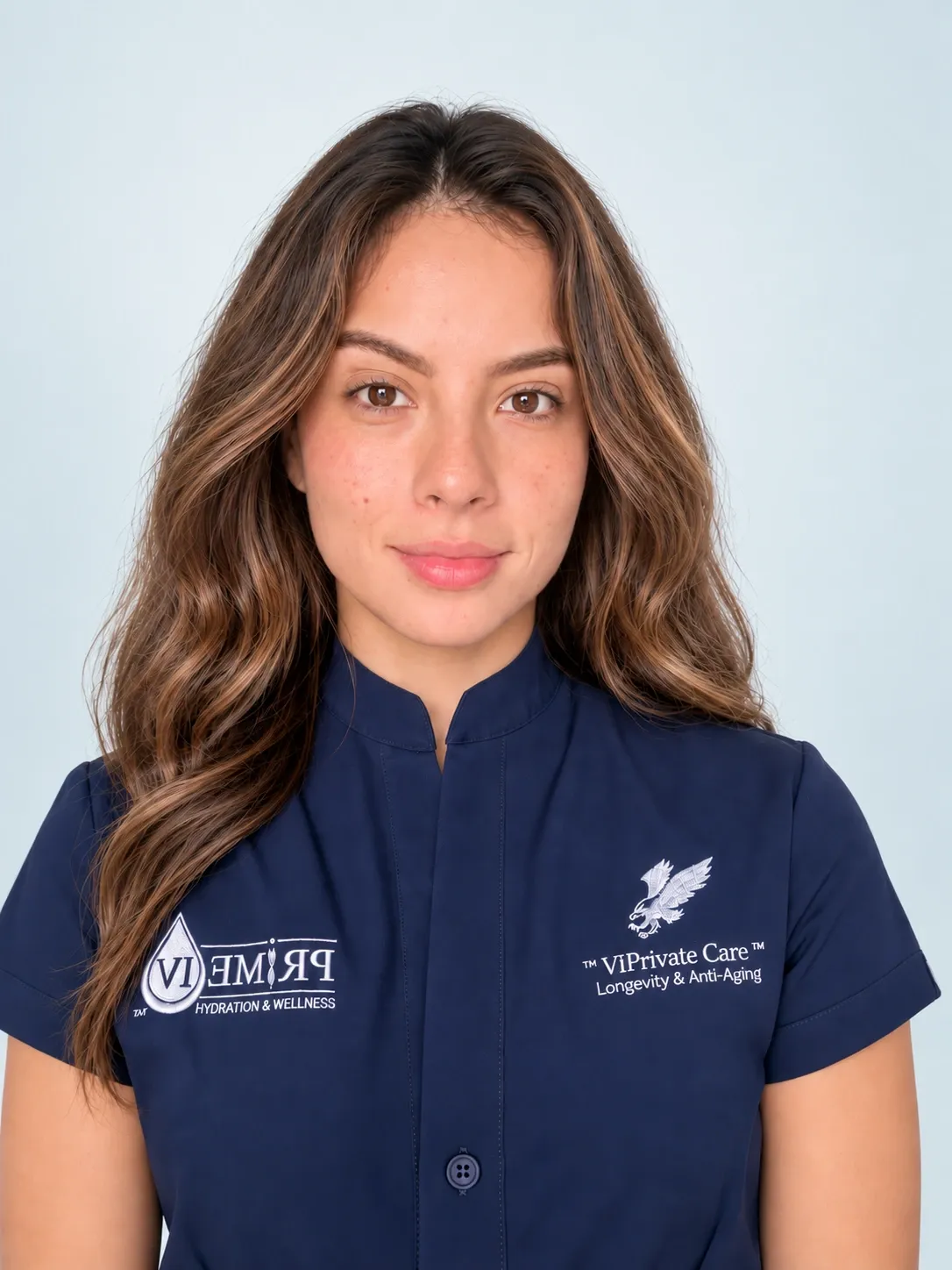Camila Perez, Spa Manager — portrait with a soft blue-gray studio background