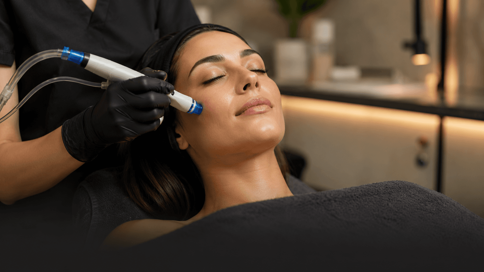A close-up facial treatment in a calm, softly lit spa room